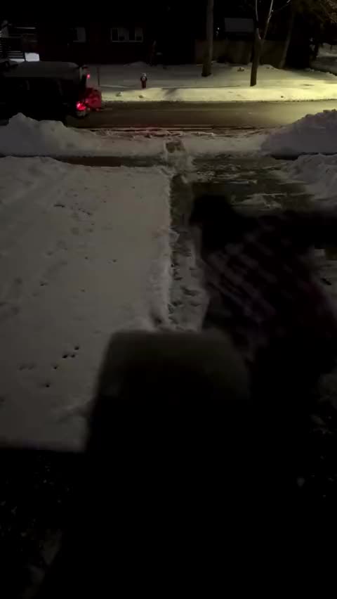 Shoveling a driveway at night